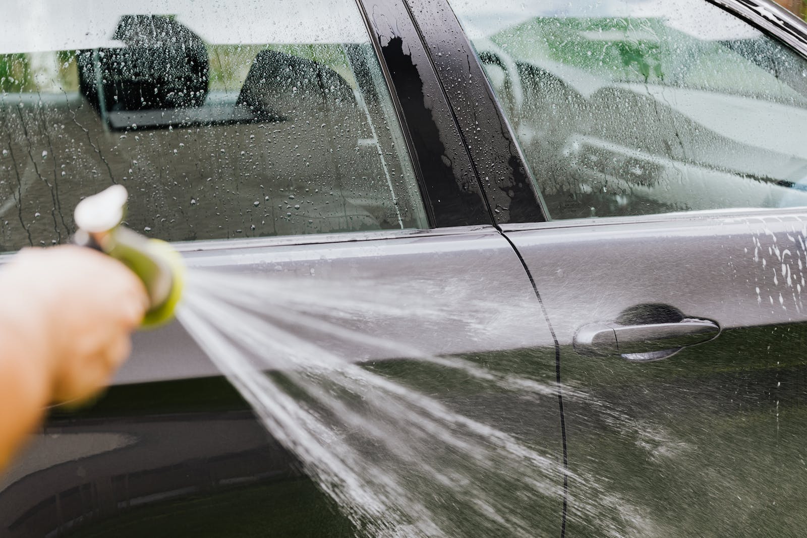 A Person Washing a Car