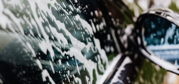 Photograph of White Foam on a Car Window