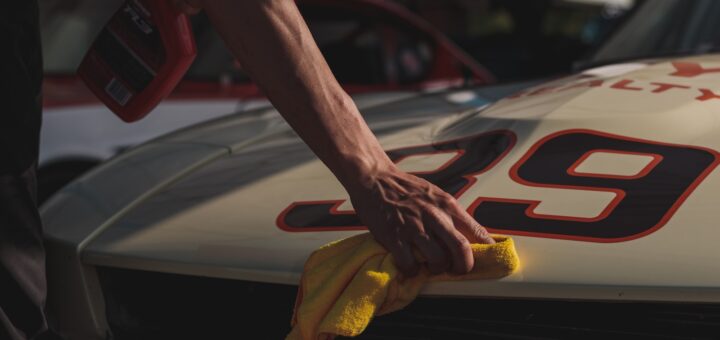 closeup photo of person wiping white racing card