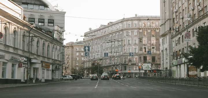 cars parked on side of the road near buildings during daytime